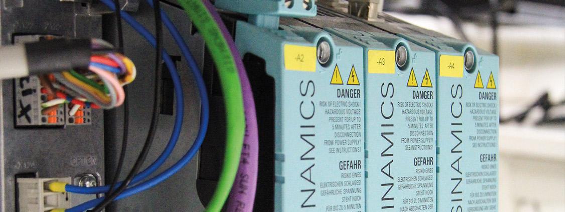 Close-up of SINAMICS industrial modules with connected electrical and communication cables